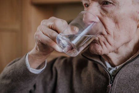 Old man drinking water closeupの写真素材
