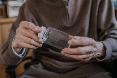 Senior holding an empty medicine bottleの写真素材
