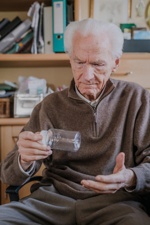 Senior holding an empty medicine bottleの写真素材