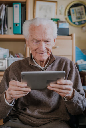 Positive Senior using Digital Tabletの写真素材