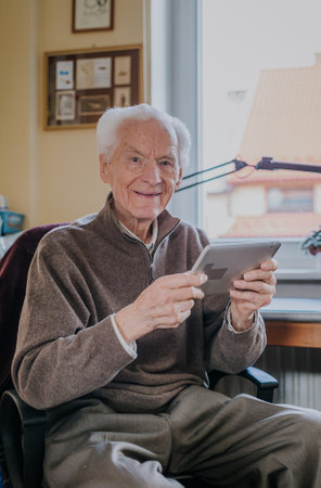 Positive Senior using Digital Tabletの写真素材