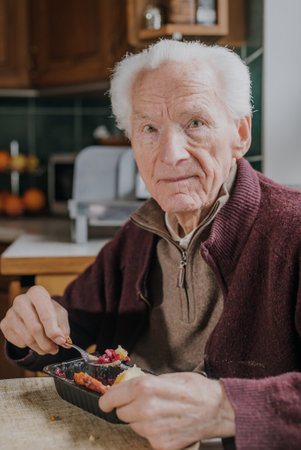 Portrait senior eats dinner at homeの写真素材