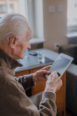 Positive Senior using Digital Tabletの写真素材