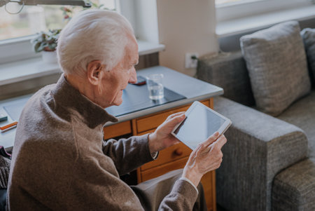 Cheerful Old man using Digital Tabletの写真素材