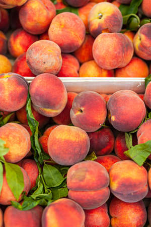 fresh ripe peaches in a boxの写真素材