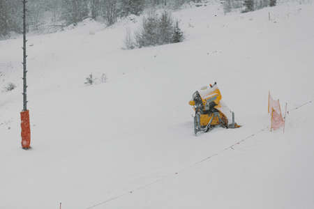 snow cannon on ski slope in winterの写真素材