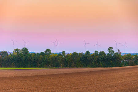 windmills turbines on sunset backgroundの写真素材