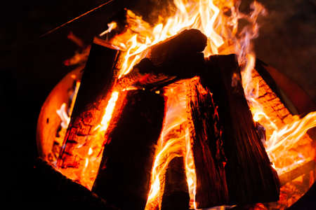 blazing fire in hearth at night close upの写真素材