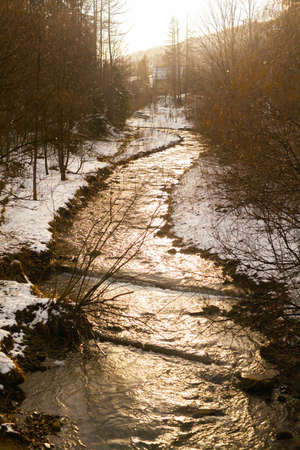 mountain stream against golden sunsetの写真素材