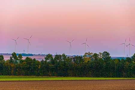 windmills turbines on sunset background