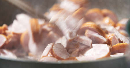 Sausage cuts frying on panの写真素材