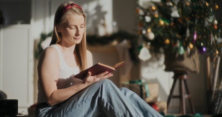 Woman Reading Book Christmas Time Relaxingの写真素材