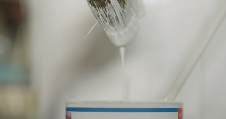 Young man painting wooden board with a white paint.の写真素材