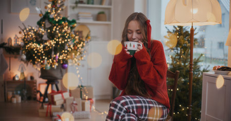 Portrait Of Woman Holding Cup Of Hot Coffee Enjoying Christmas Holidaysの写真素材