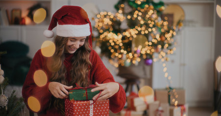 Woman Holding Christmas Gift Enjoying Christmas Holidaysの写真素材