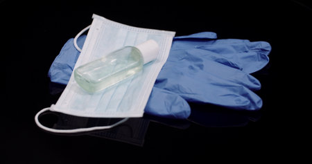 Protective Mask Isolated on Black Background Rotating. Medical Mask Protective Gloves.の写真素材