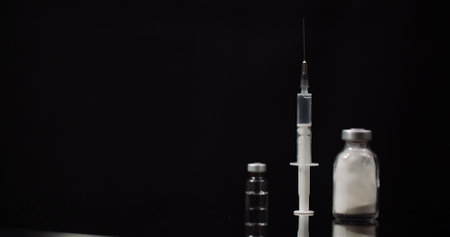 Syringe and Medicine on Black Background Isolatedの写真素材