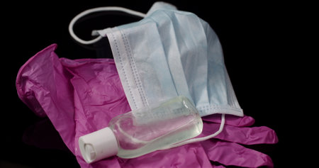 Purple Protective Mask Isolated on Black Background Rotating. Medical Mask Protective Gloves.