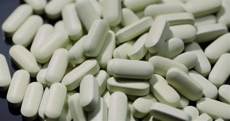 Medical tablets and pills rotating, pharmaceutical industry. Drugs Pills Isolated Black Background.の写真素材