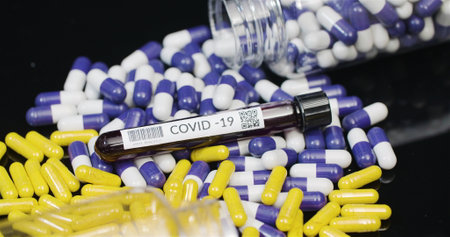 Medical tablets COVID-19 Sample Tube and pills rotating, pharmaceutical industry.の写真素材
