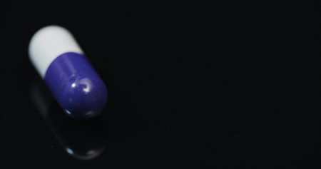 Medicine Pharmacy Concept - Extreme Close up of Pill Rotating on Black Background.