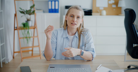Woman having Video Call Talking With Customer Online On Laptopの写真素材