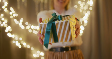 Proud and Happy Woman Hands Over a Presentの写真素材