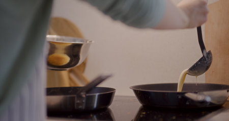 Close-Up of Pouring Pancake Batter Into Panの写真素材
