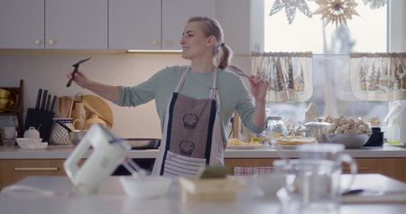 Happy Woman Dancing in Kitchenの写真素材