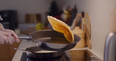 Woman Tossing Pancakes in Panの写真素材