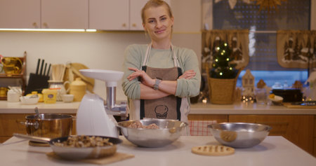 Satisfied woman in kitchen background while working smiling and happyの写真素材