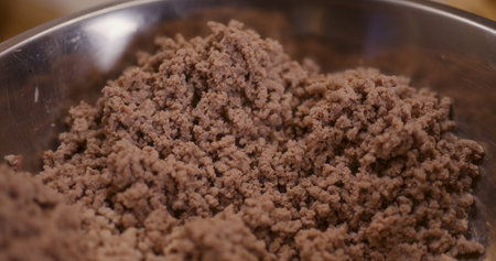 Macro shot of meat cooked and ground in meat grinder in bowlの写真素材