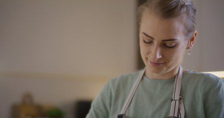 Woman working in kitchen preparing bread dough