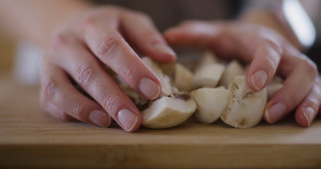 Close-Up of Sliced Mushrooms Being Pouredの写真素材
