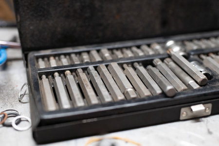 Close-up of car wheel metal bolts in plastic case