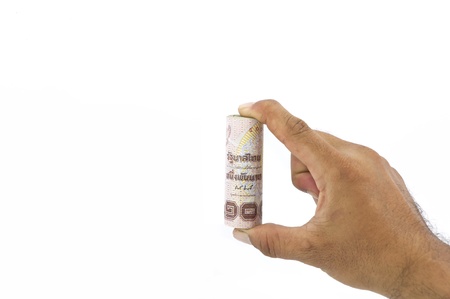 roll of one thousand baht thai banknote in hand on white backgroundの写真素材
