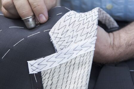 Production process of suit tailoring, hand sewing of a tailored jacket