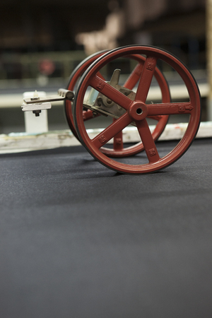 fabric at quality control. with a counting machine measuring the length of a textile piece /roll. production of fine woolen fabrics for suitsの写真素材