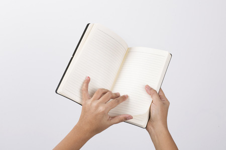 Open white book - A hand flipping pages