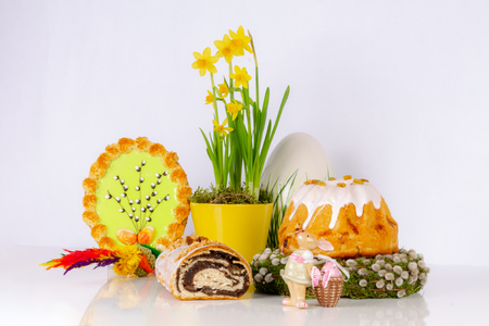 Easter composition with yeast cakes, narcissus in a yellow potの写真素材