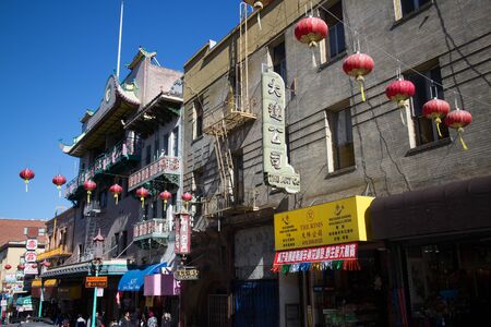 SAN FRANCISCO, CA - CIRCA MARCH 2015 - Wider view of red Chinese lanterns hanging over a street in Chinatown, San Francisco. English is seldom seen in parts of Chinatown, attesting to an Asian influx.のeditorial素材