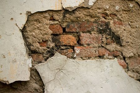 Eroded Textured Stucco Vintage Colonial Wall  in Asia with multiple Materials and Layers. Old brick,...