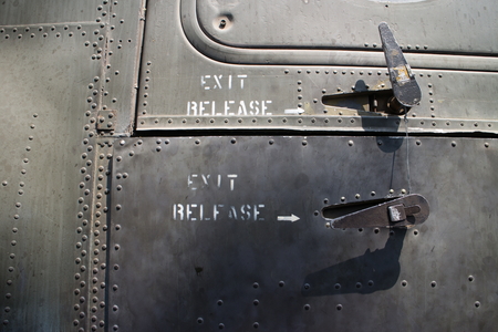 Medium shot detail of rivet pattern and exit release latches on a captured USAF aircraft from the US-Vietnam conflict, on public outdoor display in Ho Chi Minh City, Vietnam. Cockpit bubble seam is visible at top of frame.のeditorial素材