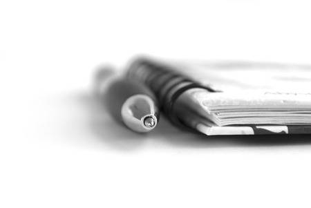 pen and notepad on white backgroundの写真素材