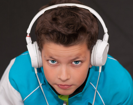 Blue eyes young boy with headphonesの写真素材