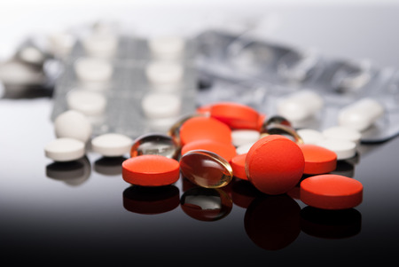 Colorful tablets or pills  on reflect backgroundの写真素材