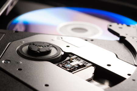 Compact disc drive with on black black backgroundの写真素材