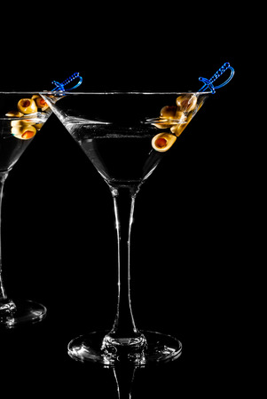 Martini glass with olive on black backgroundの写真素材