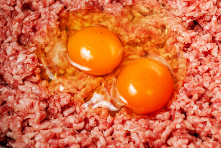 Mincet meat with eggs in food mixerの写真素材