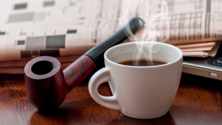 Newspaper and cup of coffee on wood tableの写真素材